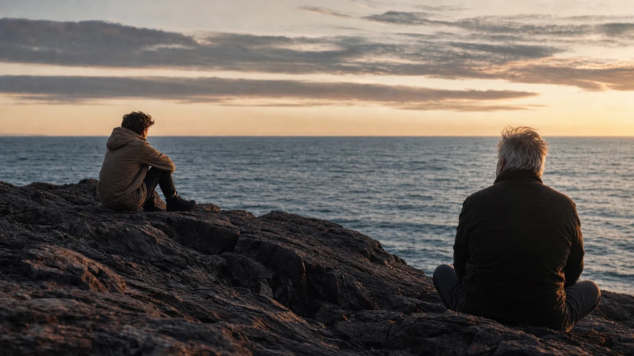 A young adult and an older adult sitting separately beside the sea in comfortable silence
